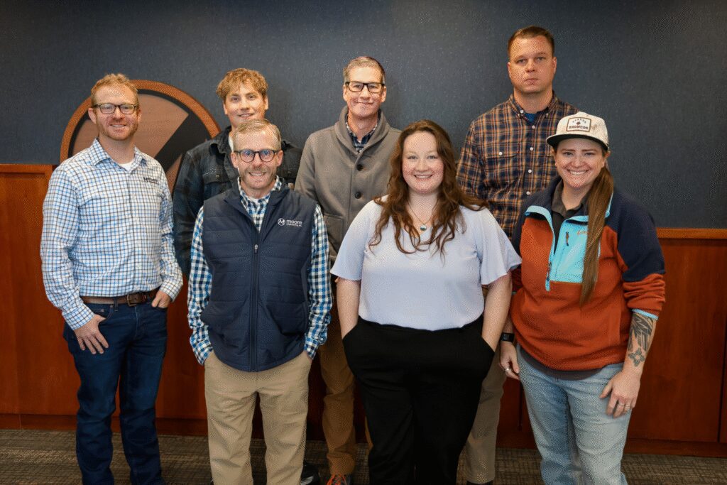 Group photo of 7 GIS team members all standing and smiling at the camera.